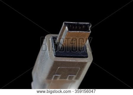 Usb Mini B Plug Isolated On A Black Background. Common 5 Pin Digital Cammera Data Connector.