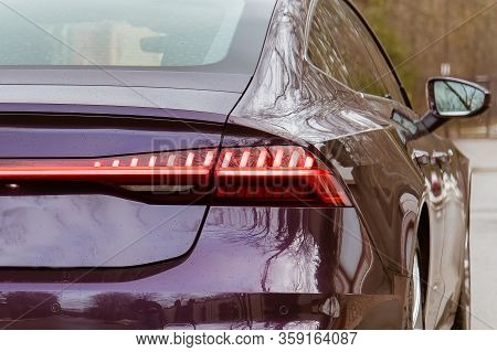 Premium Led Sedan Taillights. The Car Is Purple In The Street. Close-up