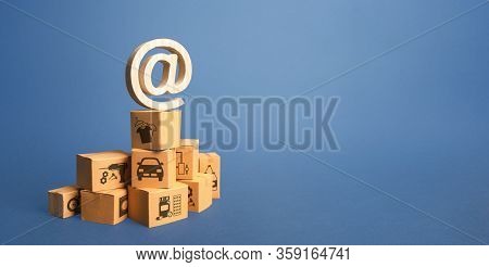 Stack Of Boxes And Email Internet Symbol. Online Internet Distribution Of Goods. E-commerce. Network