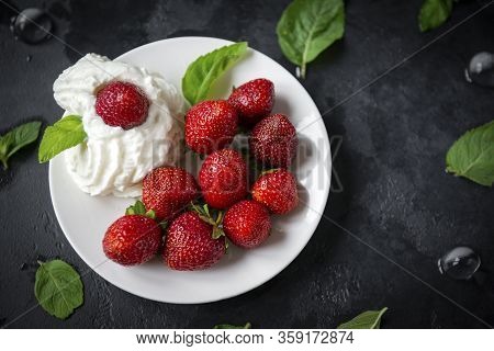 Strawberries With Whipped Cream On A Plate, Mint Leaves On A Black Background, Fresh Berries, Desser
