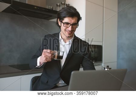 Businessman Works From Remote At House With A Laptop Due To Coronavirus Quarantine.