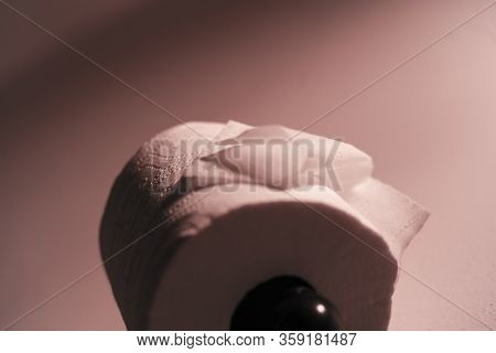 Dramatic Close Up Of Toilet Paper Supply