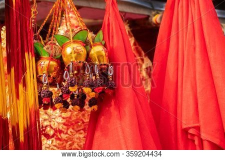 Small Golden Copper Buckets With Auspicions Hindu Red Symbols On Them, Leaves, Coconuts With Worship