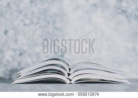 Education And Self-improvement, Pile Of Open Books Shot From Eye Level With Shallow Depth Of Field