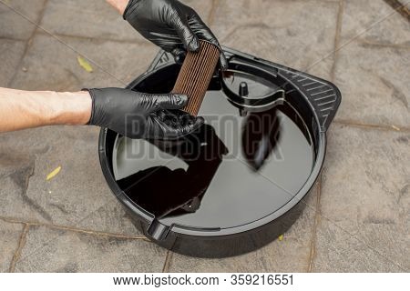 Used Drained Motor Oil In A Black Tray And Used Oil Filter. Diy Change Engine Motor Oil. Disposing O