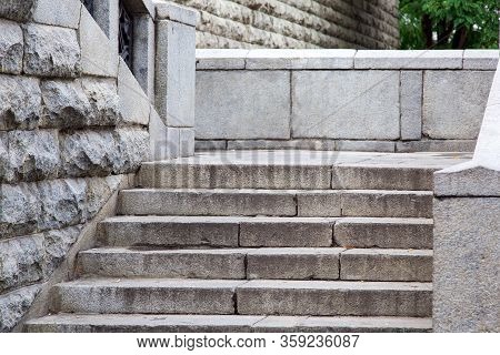 Stone Stairs Made Of Gray Rough Stone Old Stairs On The Street Of A European Town, Nobody.