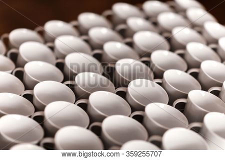 A Lot Of White Coffee Cups. Top View On Many Stacked In Rows Of Empty Clean White Cups For Tea Or Co