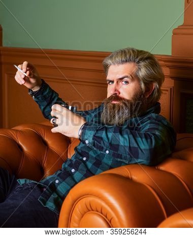 Smoke Cigarette While Drink Brandy Or Cognac. Hard Beverage For Real Men. Brutal Man Drinking Whiske