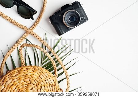 Flat Lay Stylish Traveler Accessories With Tropical Palm Leaf Branches On White Background. Top View