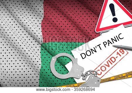 Madagascar Flag And Police Handcuffs With Inscription Dont Panic On White Paper. Coronavirus Or 2019