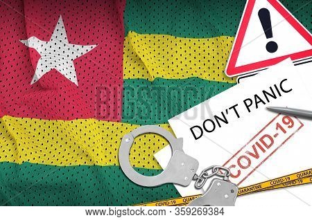 Togo Flag And Police Handcuffs With Inscription Dont Panic On White Paper. Coronavirus Or 2019-ncov 