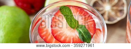 On Table Is Glass With Drink, Ice And Strawberries. Cocktail Recipes For Every Taste. Tectas And Met