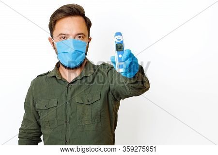 A Male Person Being Measured Body Temperature With A Contactless Thermometer And Shows The Dial 36.6