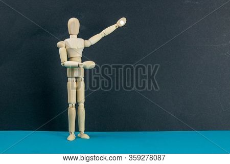 Wooden Mannequin On Black Table And Blue Background. Trun Right Concept. Close-up