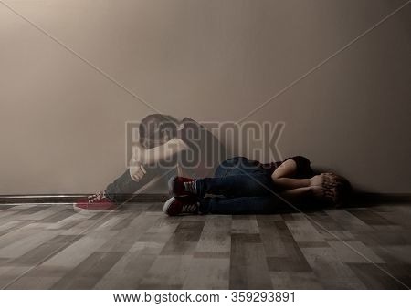 Upset Little Girl Alone Near Beige Wall. Autophobia