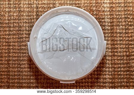 Bucket Of White Spackle Compound - Shot From Top