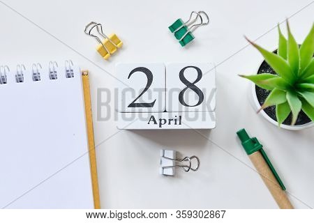Date On White Wooden Cubes - The Twenty Eighth, 28, April On A White Table. Top View. Close Up.