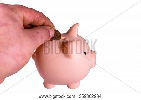 Man Putting Cent Coin In Pink Piggy Bank. Isolated On Wjite Background