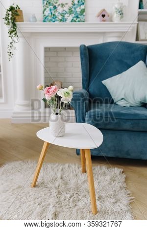Vertical Image Of A Bunch Of Flowers In A Vase On A Tea Table In A Nicely Decorated Room