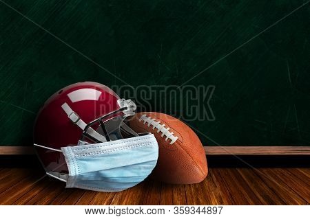 Football Helmet Wearing Surgical Mask On A Background Chalk Board With Copy Space For Text. Concept 