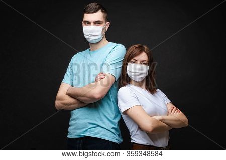 Young Couple Wearing Protective Masks. Stock Photo Portrait Of A Young Caucasian Couple In Aseptic S