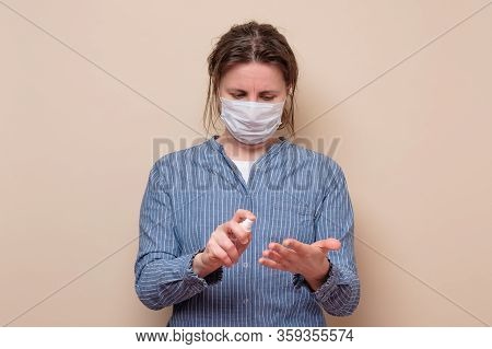 Young Woman Spraying Her Hands With Sanitizer Protecting Herself From Virus.