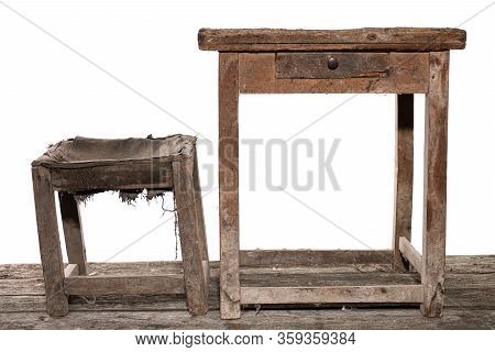 Very Old Wooden Shoemasters Workplace, Vintage Table And Chair In The Dust