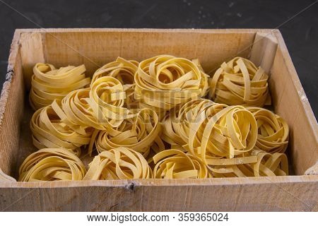 Raw Tagliatelle In A Wooden Box. Front Views