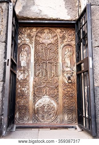 Sevan Peninsula. Armenia-may, 01 2019: Carved Wooden Door With Biblical Plot. Sourp Arakelots, Sevan
