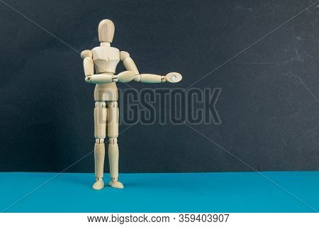 Wooden Mannequin On Black Table And Blue Background. Trun Right Concept. Close-up