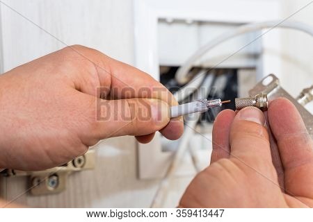 Worker Inserts Connector Of A Tv Antenna Coaxial Cable.