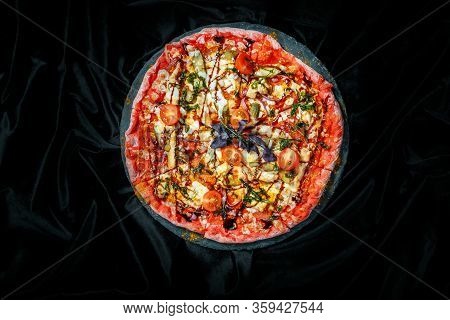 Tasty Pizza On Black Background. Top View Of Hot Pizza.