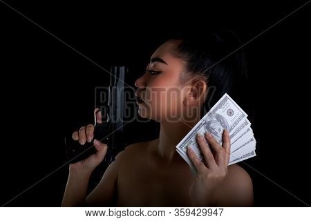 Portrait Beautiful Asia Woman One Hand Holding A Gun And Money Banknote 100 Dsd At Black Background,