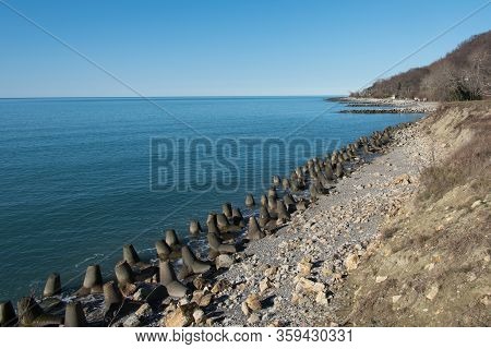 Tetrapod Breakwaters On The Coast. Concrete Breakwaters Of Tetrapods Lie All Along The Coast.