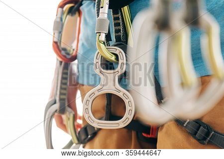 Close-up Of Unrecognizable Woman In Safety Harness With Climbing Equipment Holding Quickdraws.