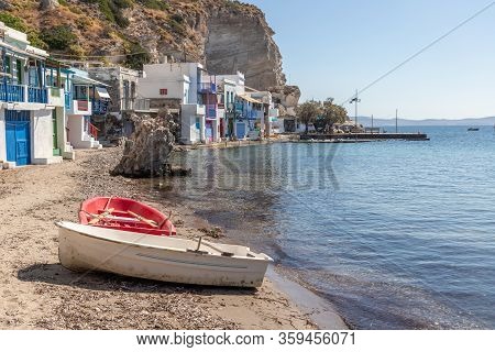 Boat And Coloured Houses In Klima Beach