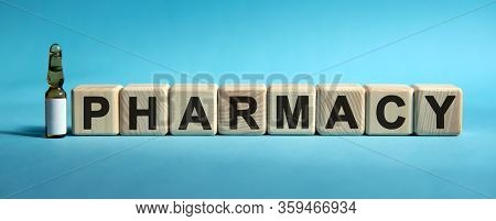Pharmacy - Word On Cubes. Drug In Ambula To Reduce Disease Symptoms On A Blue Background