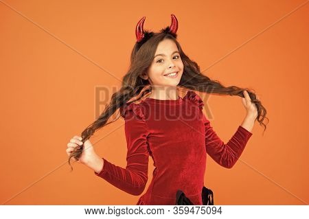 Beautiful Small Imp. Girl Red Horns Celebrate Halloween. Carnival Concept. Small Child With Imp Styl