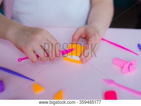 Child Hands Playing With Colorful Clay. Homemade Plastiline. Girl Molding Modeling Clay. Homemade Cl