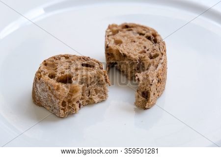 Slices Of Healthy And Nutricious Brown Bread On A White Plate
