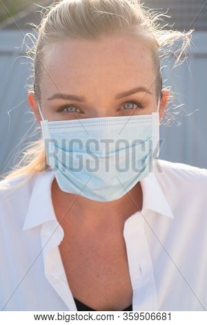 Portrait of woman in protective mask against flu and viruses outdoors. Helathcare, flu epidemic, dust allergy, virus protection, air pollution concept
