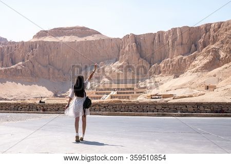 Young Brunette Female In White Dress Walks In Front Of Part Of The Mortuary Temple Of The Queen Hats