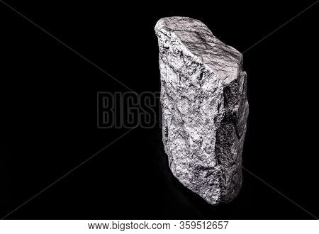 Raw Manganese. Manganese Stone Isolated On Black Background. Mineral Extraction Of Heavy Metals.