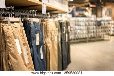 Modern Fashion Women Clothes Hang On Stanless Steel Hangers Rack At Cloth Shop Department Store. Cas