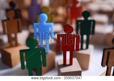 Colored Wooden Figures In Form Man Stand Table. Desire To Perform Tasks That Are Prescribed In Job D