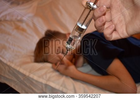 Vaccination Of The Child. Big Scary Syringe. Frightening Doctor . Mandatory Vaccination Of Children.