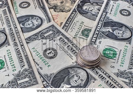 Coin Ruble On The Background Bills Dollar.