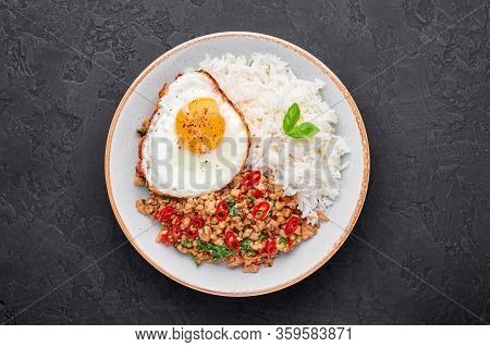 Pad Krapow Gai - Thai Basil Chicken With Rice And Fried Egg Black Slate Background. Pad Krapow Is Th