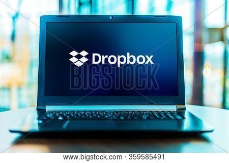 Poznan, Pol - Mar 24, 2020: Laptop Computer Displaying Logo Of Dropbox, A File Hosting Service Opera