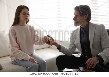 Psychotherapist And Patient In Office. Hypnotherapy Session